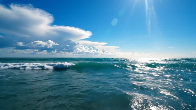 Bright sun shines over deep blue ocean waves