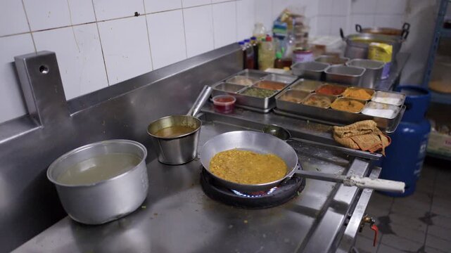 Chef Preparing Indian Curry in Professional Stainless Steel Kitchen