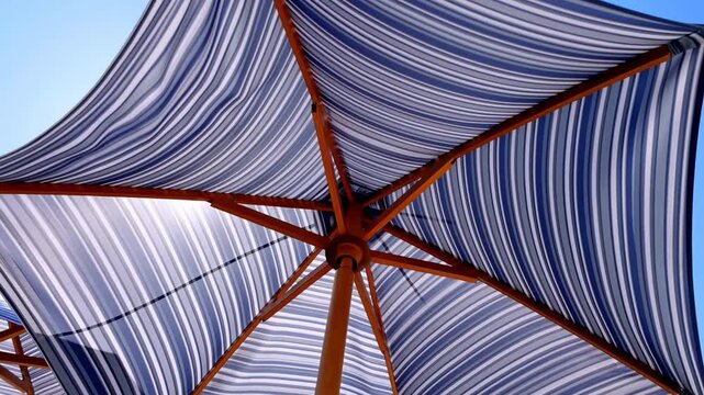 Parasols Viewed From Below Against Bright Blue Sky