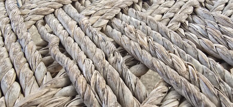 Rustic woven rope texture close up, weathered hemp fiber pattern, organic braided twine surface for background and interior design