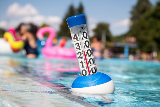 Sommer:  ein Poolthermometer in einem Freibad zeigt eine Wassertemperatur von 27 Grad Celsius an.