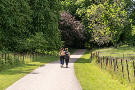Couple walking on rural path in green countryside