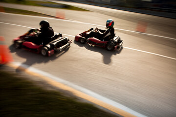 Naklejka premium High angle motion blur shot of two go karts racing on a track