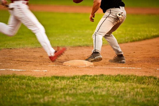 Close up action shot of a baseball player running to first base