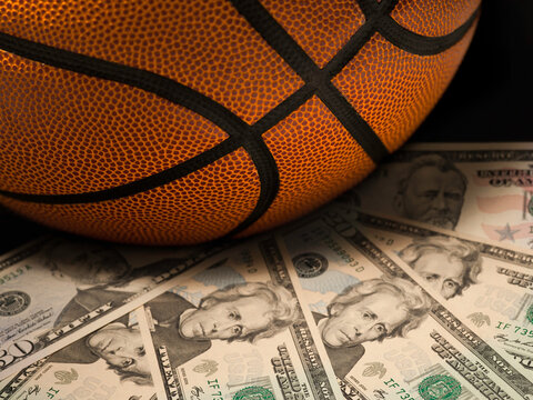 Basketball gambling concept on a pile of US dollar bills