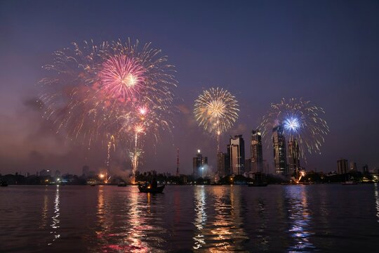 city skyline fireworks celebration over waterfront at night festive event holiday background scene