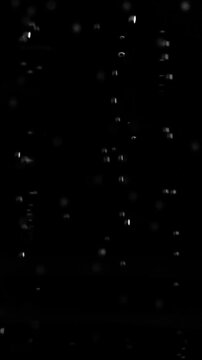 Vertical clip of big large air bubbles floating and rising nonstop on solid black background.