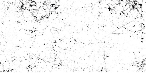 Black and white cracked texture with scattered debris on white background for design and black ink splatters and scratches . © Amena