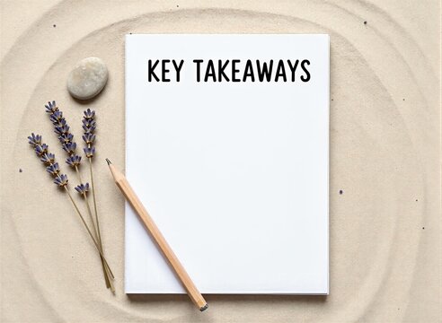 Piece Of White Paper Prominently Placed On To Sand With Textured Surface Resembling Beach Desert Terrain Title Key Takeaways Printed In Bold Black