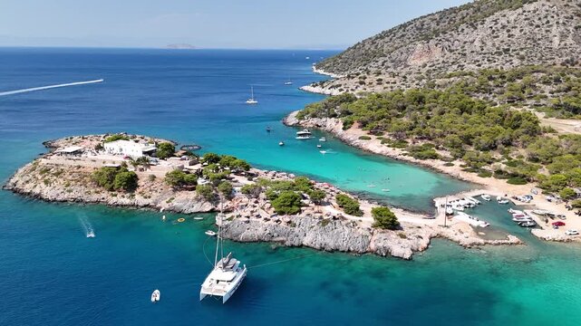 4K drone footage of the beautiful Aponisos island, a unique and picturesque small island connected to Agistri by a narrow strip of land, surrounded by vivid turquoise waters of the Medite