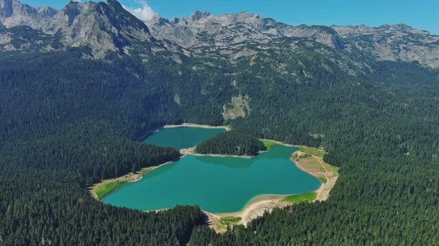 Aerial around view of Black Lake in mountain Durmitor park at summer, Montenegro, 4k