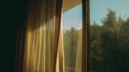 Fototapeta premium Sunlight pours through curtains in an open window beside green trees