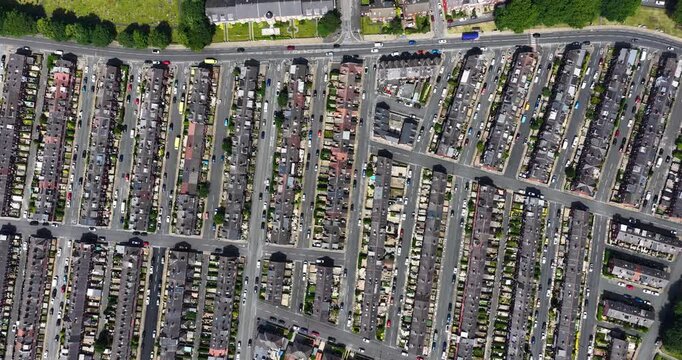 Aerial view of dense Victorian terraced housing in Beeston Leeds West Yorkshire showing residential streets parked vehicles urban layout and community neighbourhood pattern from above in the summer