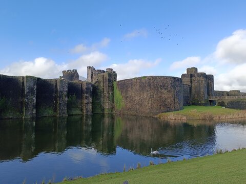 Beautiful panoramic view of the medieval Caerphilly Castle ruins under blue sky, South Wales, UK