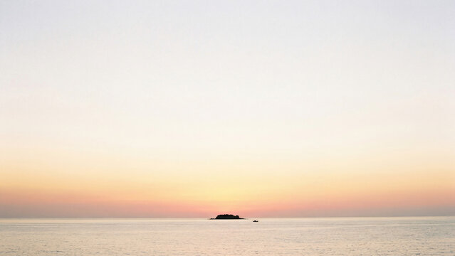 Summer sunset golden hour minimalist ocean island silhouette peaceful tranquil seascape scene for poster design background wallpaper banner template