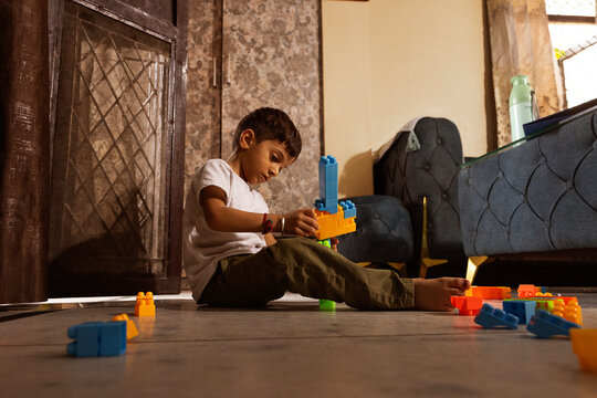 Boy constructing with blocks on floor