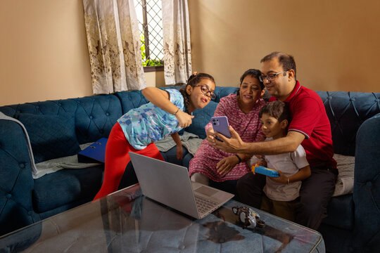Family taking a selfie on sofa
