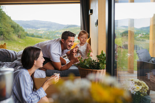 Family spending summer weekend away in cottage house in countryside.