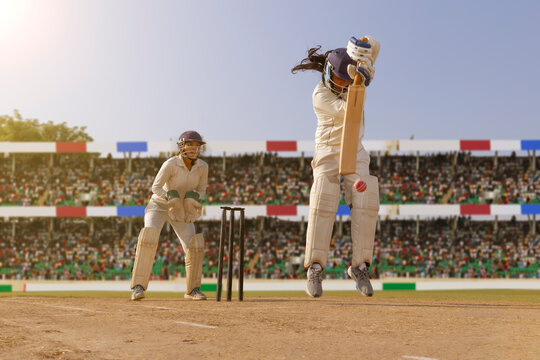 Female cricketer jumping to avoid a bouncer