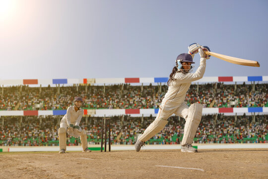 Female cricketer executing a powerful shot