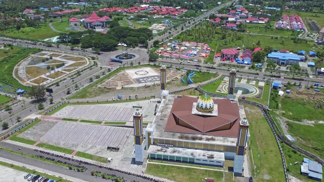 An aerial shot of a magnificent mosque Masjid Raya Shaful Khairaat Sofifi Tidore with mountains and the sea. Ideal for projects on religion, travel, and culture