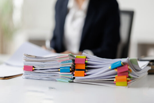 Serious professional businesswoman in office working with Documents, Business, accountant Documents documents at her desk in a modern office environment
