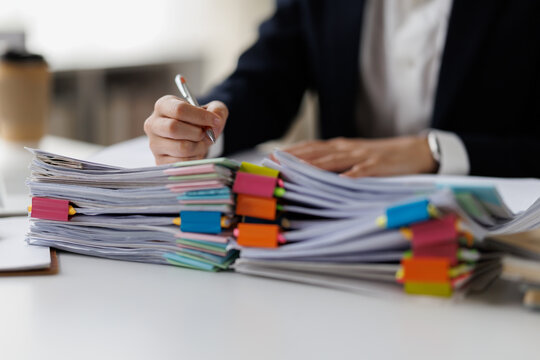 Serious professional businesswoman in office working with Documents, Business, accountant Documents documents at her desk in a modern office environment
