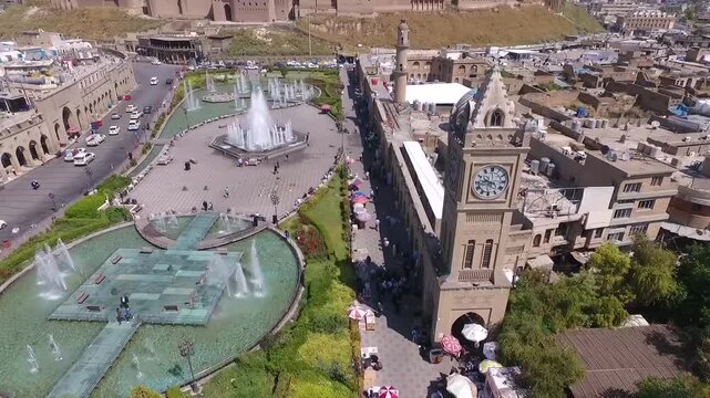 Birds-eye drone footage sweeping over the archaeological mound of Hawler, showing the fortified city walls of the Erbil Citadel. Beautiful aerial overview highlighting traditional mudbrick structures 