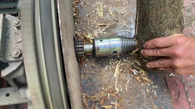 Close up of a homemade electric cone log splitter splitting a wooden log