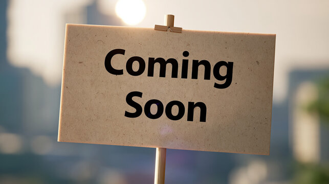 Coming soon paper sign on stick with blurred city background and warm light, marketing campaign teaser for launch announcement