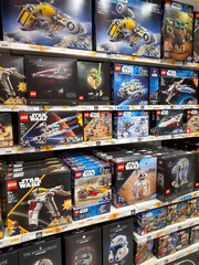 Naklejka premium Dubai, UAE - May 26, 2026: LEGO Star Wars construction sets displayed on retail shelves. Licensed collection remains popular among collectors, hobbyists and science fiction fans