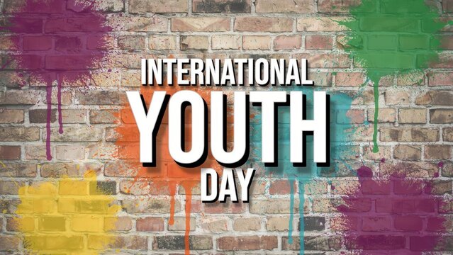 International Youth Day celebration text on colorful paint splatter brick wall background