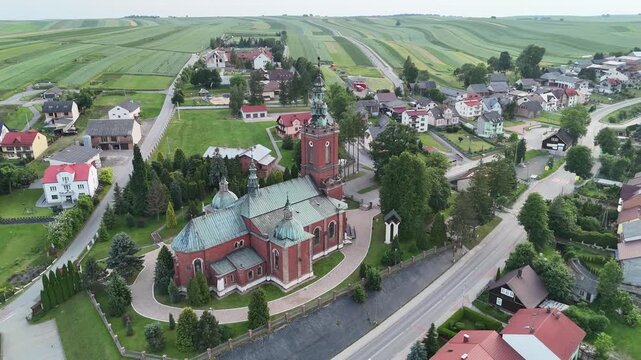 Aerial Drone View of the Church in Sułoszowa with Iconic Striped Farmland in the Background, Poland