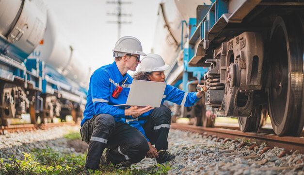 Team of engineer railway hecking under train ,wheels and control system for safety travel passenger.
