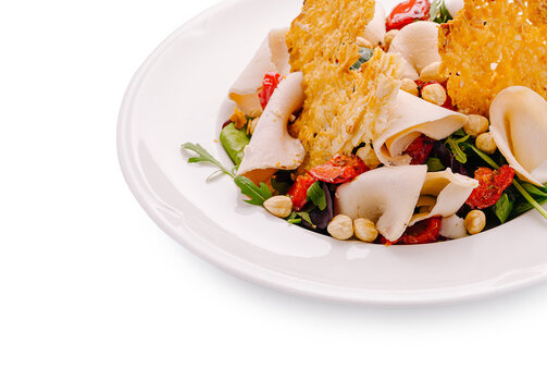 Chicken salad with sun-dried tomatoes, arugula, and parmesan crisps