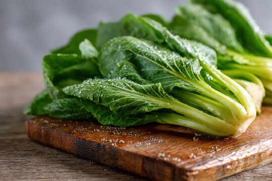 Crisp choy sum stalks with vibrant leaves, water droplets, kitchen lighting