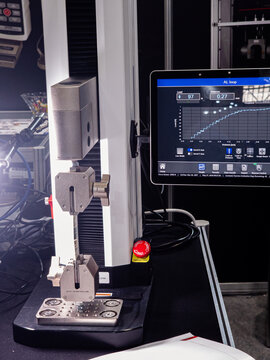 Universal Tensile Testing Machine in Laboratory with Digital Display Showing Load and Distance Graph