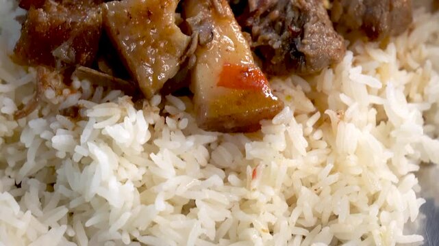Tilt up shot of boiled pork served with rice in trational Northeast Indian Assamese style