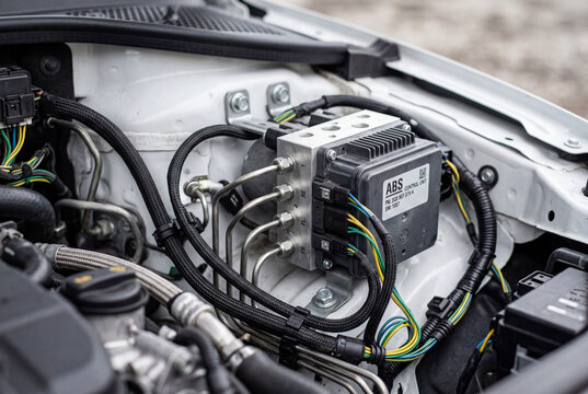 Automotive antilock braking system control module installed in a clean vehicle engine bay