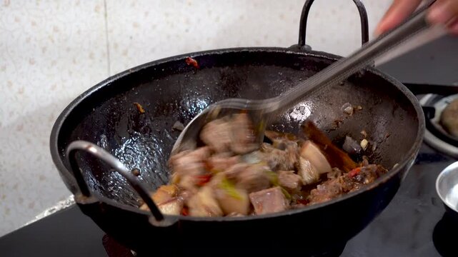 Wide shot of cooking pork in traditional tribal style of Northeast India Assam