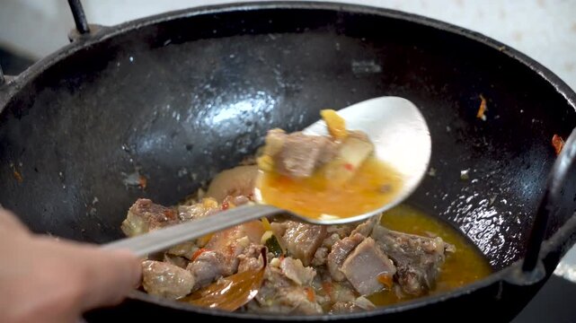 Wide shot of cooking pork in traditional tribal style of Northeast India Assam 2