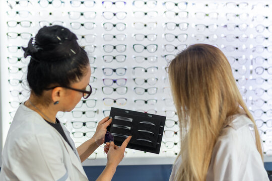 Optician explaining lens thickness options to customer
