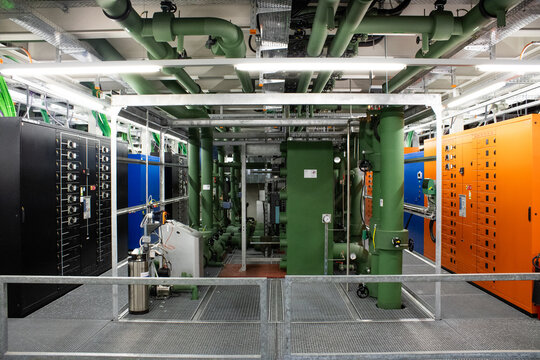 Lugano, Ticino, Switzerland - 18 March 2026: View of the Swiss National Supercomputing Centre featuring complex industrial cooling pipes and server infrastructure.