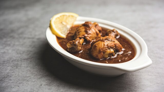 Homemade chicken nihari with rich aromatic gravy and fresh lemon garnish