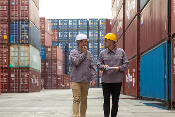 Two shipping company workers at commercial dock site. Group of male worker control loading...