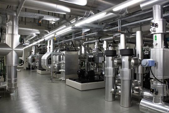 Lugano, Switzerland - 18 March 2026: View of the technical infrastructure and cooling systems at the Swiss National Supercomputing Centre, with metallic pipes and industrial machinery.