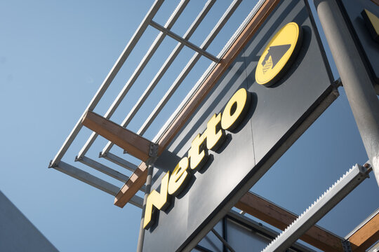 Advertising banner with the name of a retail chain in Poland, Netto. Poznań, Poland June 21, 2026