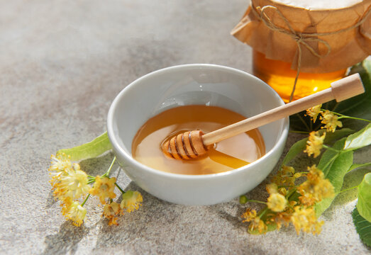 Linden honey bowl with wooden dipper and flowers