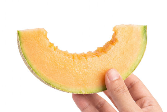 Hand Holding a Bitten Slice of Fresh Cantaloupe Melon