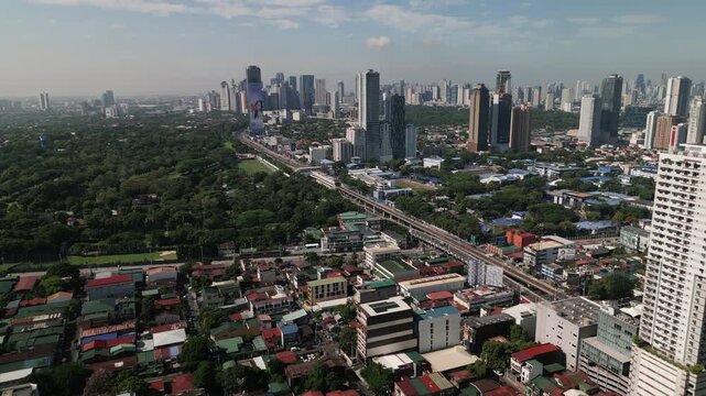 Aerial view of Quezon City, Metro Manila, Philippines with skyline towers, urban districts, and major transportation corridors